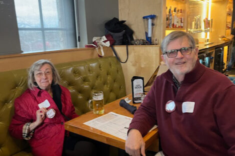 A man and a woman are seated at a table.