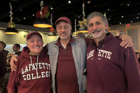 Three people dressed in Lafayette shirts are smiling at the camera.