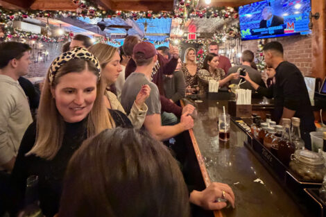 A photo of alumni in a crowded bar