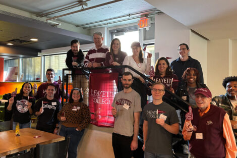A group of alumni are gathered in a restaurant.