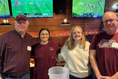 A group of alumni are seated in a restaurant.