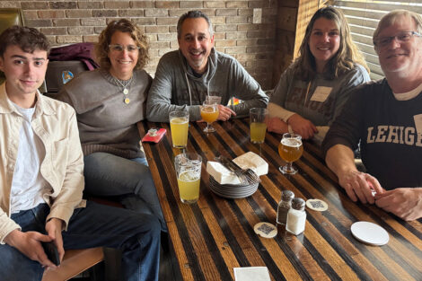 Alumni are seated at a table in a restaurant.