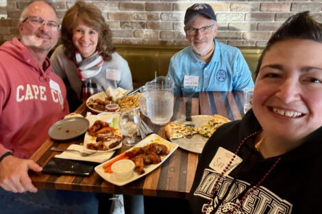 Alumni are seated at a table.